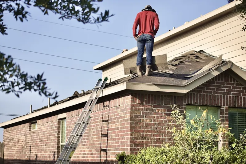 Professional roofer working on a residential roof in Emerald Hills
